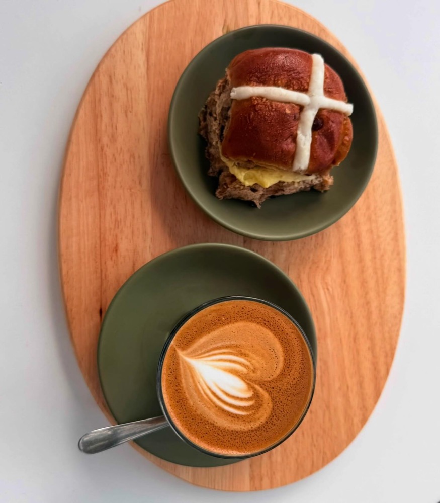 Hot cross bun and latte with heart art